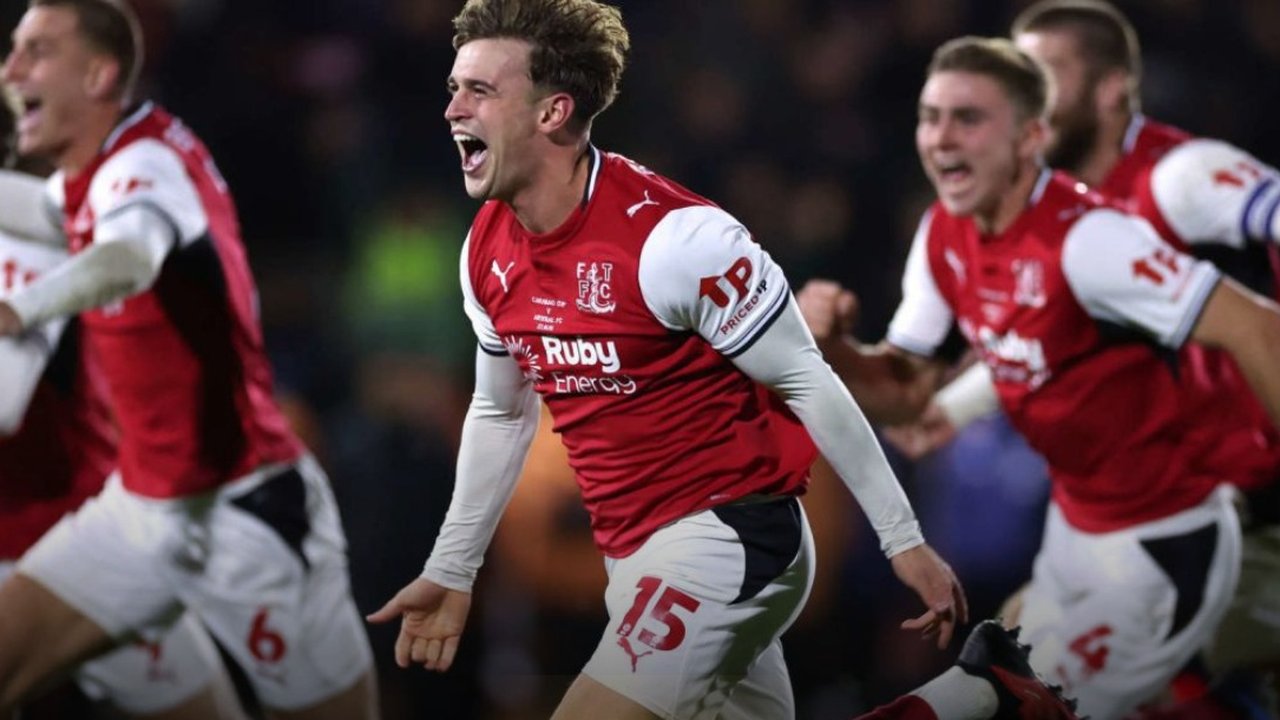 Fleetwood Town players run to celebrate after knocking Arsenal out on penalties