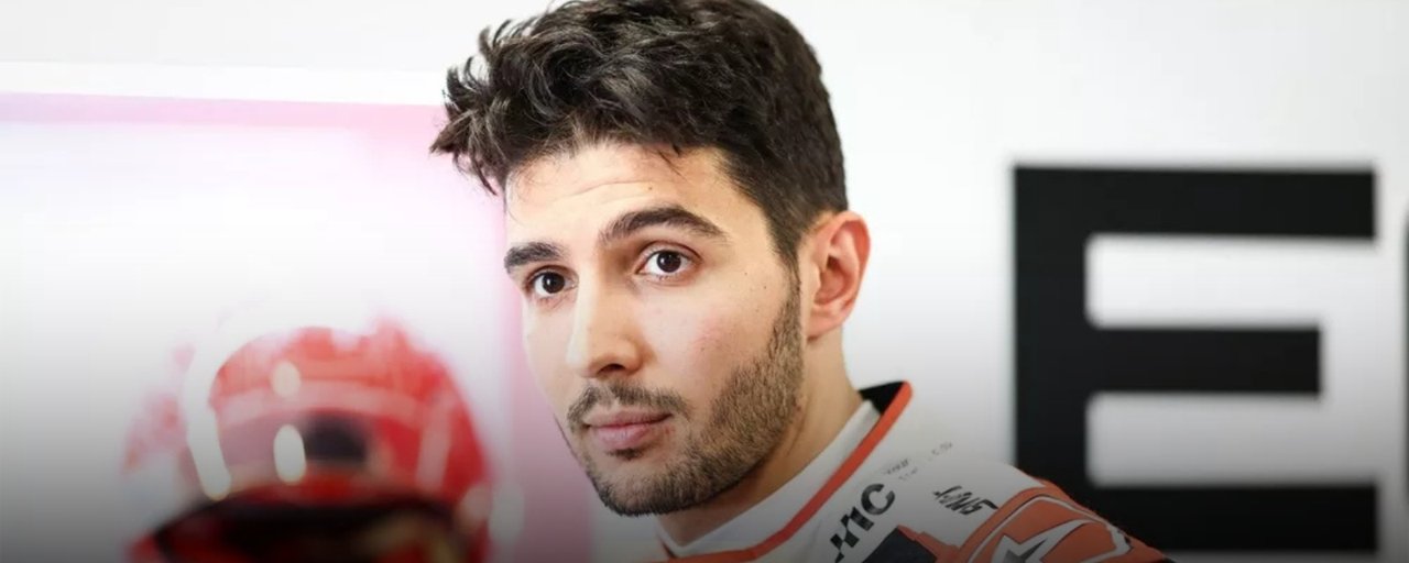 Esteban Ocon in his Haas race suit in the team garage