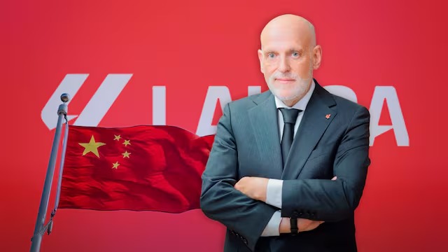 LaLiga president Javier Tebas with his arms crossed next to a Chinese flag